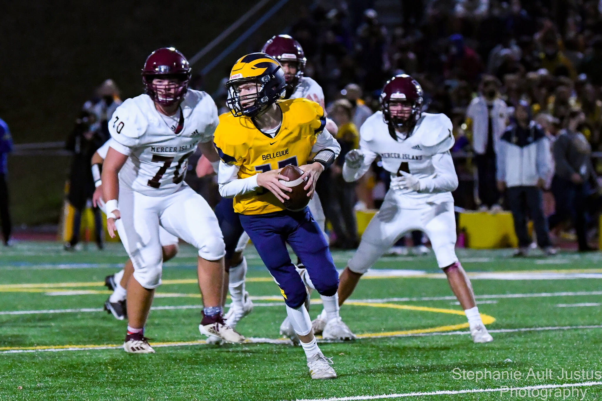 Bellevue quarterback Lucas Razore prepares to pass while Mercer Island’s Griffin King and Alexander Espinoza defend. Photo courtesy of Stephanie Ault Justus