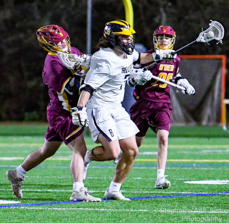 Bellevue senior Wiley Bryant (#7) rushes past Georgios Kotsakis (#16) and Graham Benson (#26). Courtesy of Stephanie Ault Justus.