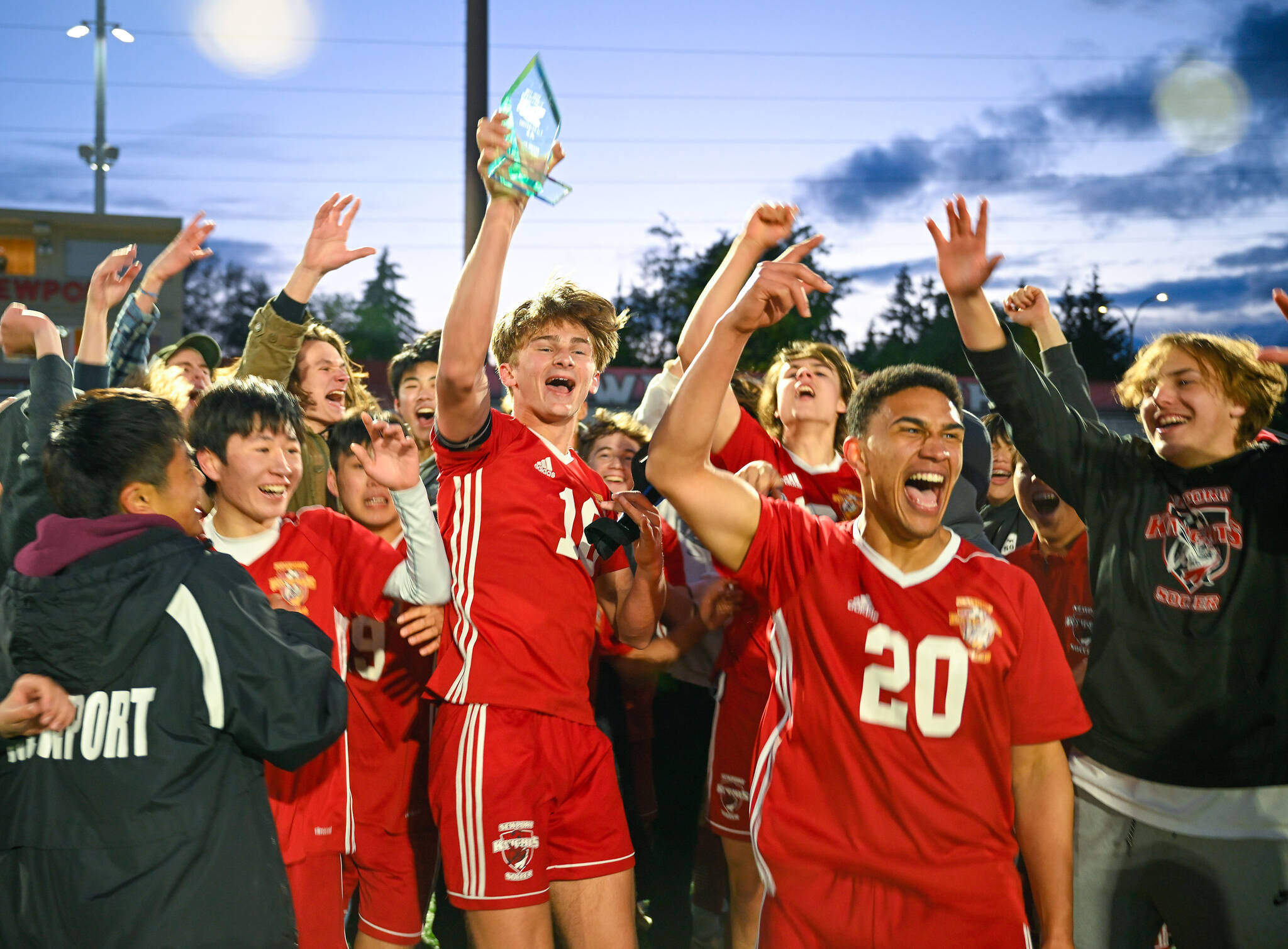 Chad Sovde (#10) holds an award while cheering alongside Akil Appollis (#20) after winning the playoff game on May 12. Courtesy of Patrick Krohn.