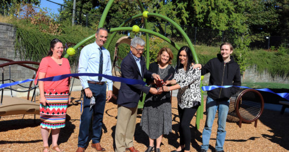 Gary Locke and Sheri Flies (center) cut a ribbon to celebrate the ELC playground renovation on September 6. Courtesy of Bellevue College.