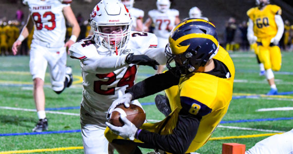 Bellevue junior Cal Zimmerman (#8) scores a touchdown as Snohomish seniors Miles Lamb (#8) and Easton Leonard (#24) attempt to tackle. November 4, 2022. Courtesy of Stephanie Ault Justus.