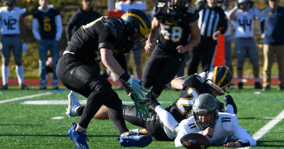 Bellevue junior Tate Hauser (#20) tackles Mead’s quarterback, Colby Danielson (#11), who fumbles the ball. November 12, 2022. Courtesy of Stephanie Ault Justus.