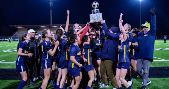 The Bellevue High School girls varsity soccer team holds up the 3A State Championship trophy. Courtesy of Stephanie Ault Justus.