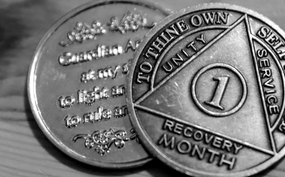 One person’s month recovery coins after battling a fentanyl addiction. (Kevin Clark / The Herald)