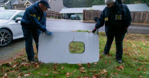 The plane door that flew off of the Alaska Airlines flight 1282 Boeing 737-9 MAX found by NTSB investigators in a Portland resident’s backyard. (Courtesy of NTSB)