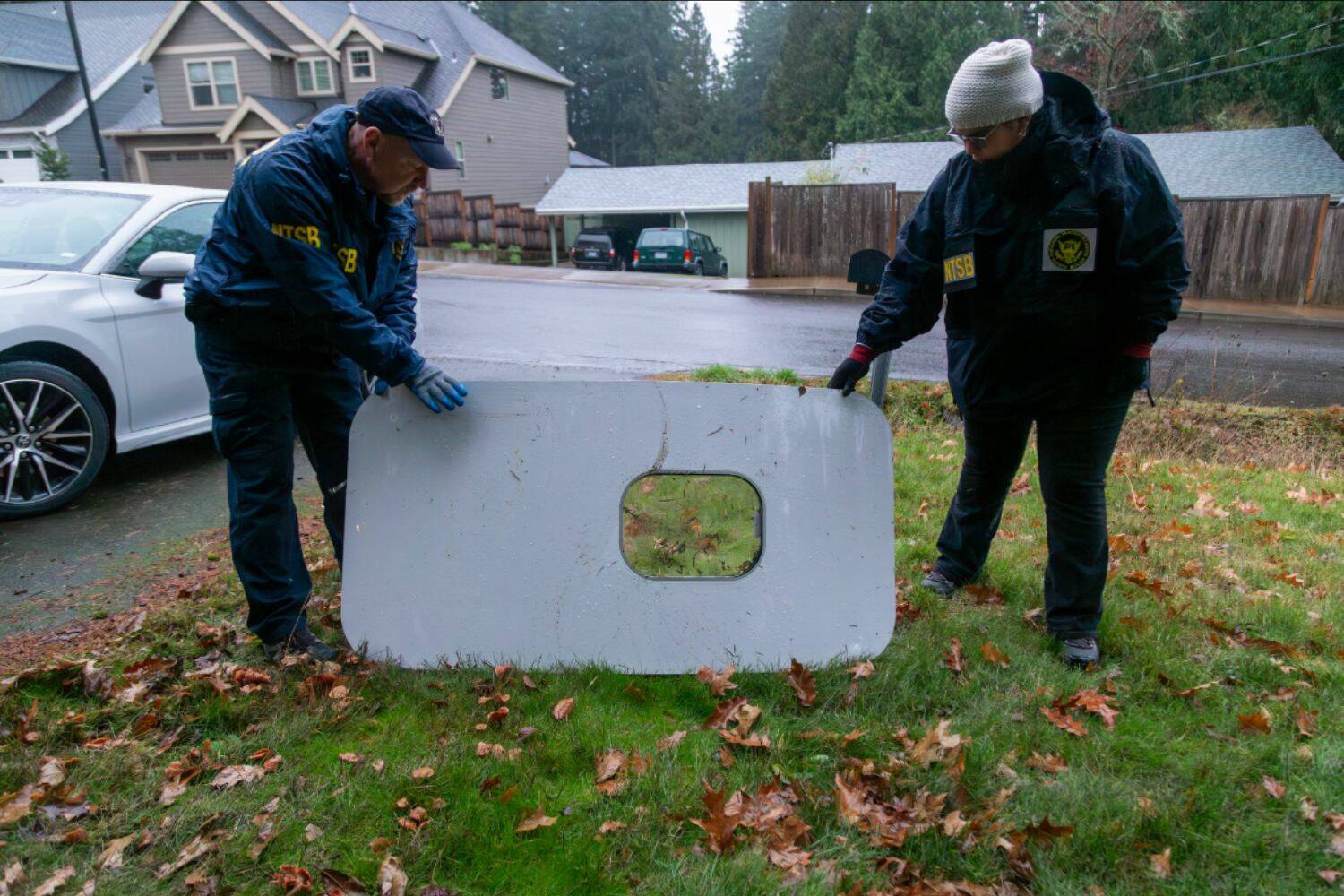 The plane door that flew off of the Alaska Airlines flight 1282 Boeing 737-9 MAX found by NTSB investigators in a Portland resident’s backyard. (Courtesy of NTSB)