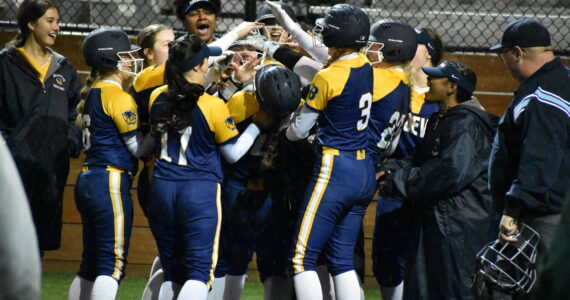 Bellevue celebrates a grand slam in the fifth inning. Ben Ray / The Reporter