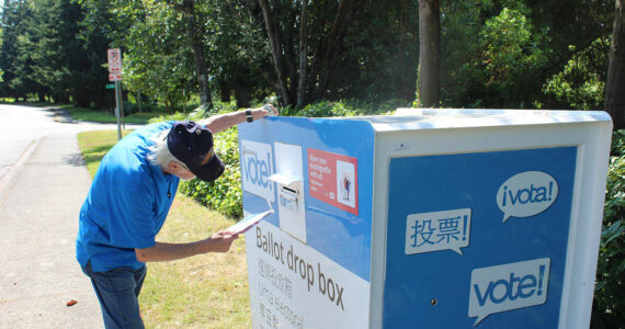 A man places his ballot into the drop box outside Federal Way City Hall. Bailey Jo Josie/Sound Publishing