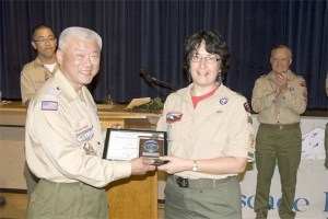 Peter Wang (left) presents the District Award of Merit to Helen Young.