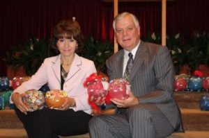 World Impact Network founder Gabiiella van Breda and Westminster Chapel senior pastor Gary Gulbranson collect the hundreds of 'piggy banks' returnd by the Westminster congregation. Together