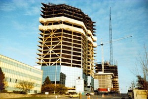 A mixture of old and new office buildings line Northeast Fourth Street in this 1983 photograph.  On the left side is the Puget Power building. Constructed in 1956
