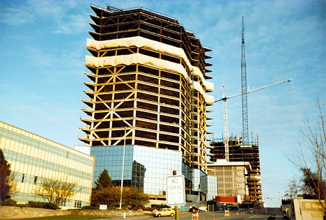 A mixture of old and new office buildings line Northeast Fourth Street in this 1983 photograph.  On the left side is the Puget Power building. Constructed in 1956