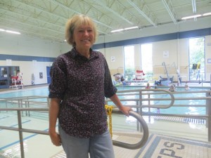 Harriet Ott stands near the specially designed ramp and stairway into the warm water therapy pool at the Bellevue Aquatic Center.