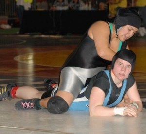 Interlake's Brandae Grein (bottom) looks towards her coaches in the corner as she battles Kentwood's Antonia Navejas in the semi-finals of the girls 152-pound weight class during Saturday's Mat Classic action at the Tacoma Dome.