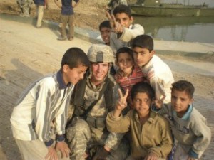 Army Spec. Tim Thorpe was named Soldier of the Month for his battalion. Here he poses with Iraqi children at a bridge-building site.