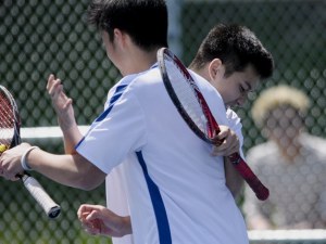 Sammamish's Benny Tran and Andrew Nguyen celebrate together after a win during the Sea-King District doubles tournament on Wednesday. Tran and Nguyen made the finals before falling to the duo from Seattle Prep