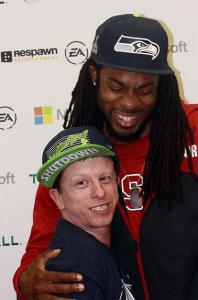 Seattle Seahawks cornerback Richard Sherman poses with a fan during Monday's release party for Titanfall