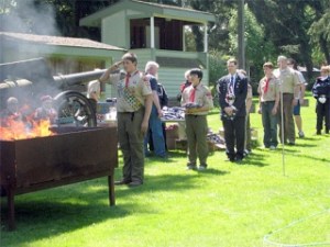 Ellis Hughes stands at the head of a line of people preparing American flags for retirement by burning them. Nearly 500 flags were retired on Sunday