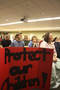 Bellevue residents displayed signs at Monday's City Council meeting to show disapproval for the new Knotty Bodies bikini espresso stand that opened Saturday near Crossroads Park.