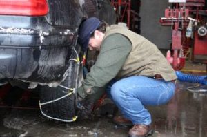 Peter Ollodart attaches chains to his car Thursday