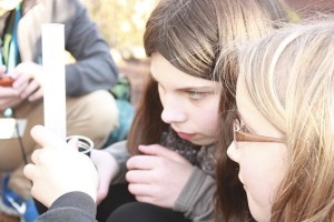 Environmental Pathways students Frances and Victoria measure out water for a soil permeation test.