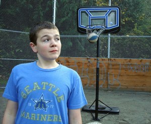 Chip Conyard of Bellevue glances over his shoulder as a basketball he shot backwards falls through a net