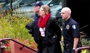 A protester is arrested during an immigration reform rally inside the Washington State Republican Party Headquarters in Bellevue on Thursday