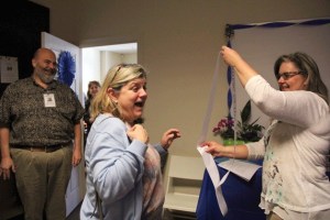 Registered nurse Elise Troske-Roberts (left) is surprised as she walks in the door at her work at BrightStar Care of Seattle/Bellevue