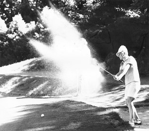 Ann Swanson hits a shot out of the sand trap in this file photo.