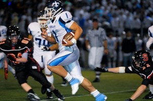 Saints RB Brett Kirschner breaks free of Totem defenders in the annual Crossroads Cup at Interlake High School in Bellevue on Friday. Interlake won 35-6.