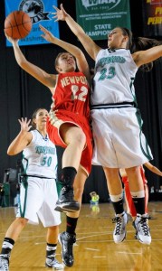 Newport's Betsy Kingma drives to the hoop past Kentwood's Liz Mills (left) and Sanda Milovic (right) in Wedneday's opening round game of the Class 4A state tournament.