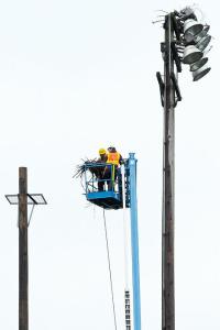 Workers from Davey Tree Expert Company in Bellevue move an osprey nest from an existing light pole to a new pole and platform dedicate to the large raptor at Hidden Valley Park in Bellevue on Monday.