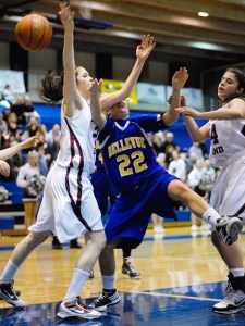 Wolverine guard Kelly Meggs (22) is fouled by Islanders forward Kate DaPron during the KingCo 3A league title game on Friday.