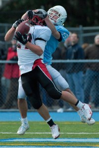 Saints WR Scotty Gehlhausen (11) turns defender as Wildcat defender Alex Galgano (27) intercepts a ball in the endzone during the first half at Interlake on Saturday. Archbishop Murphy won 58-13.