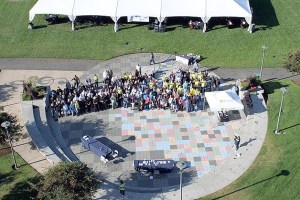A large number of Bellevue seniors smile at a photographer atop a 75-foot ladder Tuesday