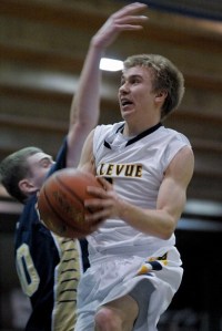 Wolverine guard Will Locke drives to the basket against a Decatur defender during state tournament play at Bellevue College on Friday.