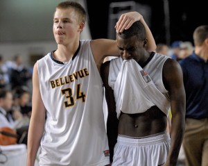 Wolverine seniors Nate Sikma (34) and Evian Richard walk off the court after falling to Lakes 71-56 in the WIAA 3A boys championship game at the Tacoma Dome on Saturday.
