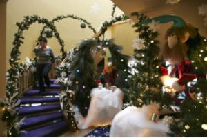 Seasonal stylist Beverly Burrows walks down the stairway of a home Tuesday
