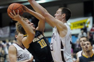 Wolverine guard Timmy Haehl (10) drives and scores against Islander defender Brian Miller during KingCo league tournament play at Bellevue College on Tuesday. Bellevue won 46-44 to advance to the title game on Thursday.