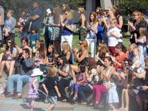 People applaud after hearing a speech from parent Carolynn Brown