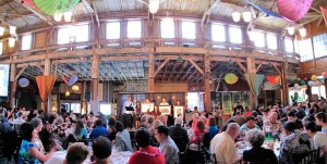 Over 250 guests attended EDI's 'Inclusion Fusion' benefit dinner and auction at SODO Park on May 20. Laura Michalek (center) prompts bids for three George Tsutakawa framed Sumi-e paintings valued at over $1