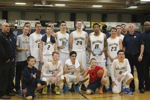 The Bellevue Wolverines boys basketball team gathers together for a trophy presentation following their 65-47 victory against the Mercer Island Islanders in the Class 3A KingCo championship game on Feb. 12 at Bellevue College.