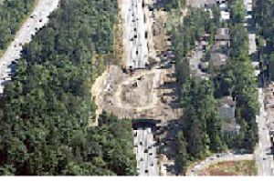 An aerial view of the Wilburton Tunnel in July shows trucks removing dirt in preparation for knocking down the tunnel next weekend.