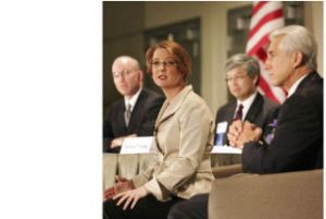 Congressional candidate Darcy Burner answers a question as incumbent Rep. Dave Reichert looks on during Wednesday’s U.S. House of Representatives 8th Congressional District debate at Meydenbauer Center in Bellevue.  In the background