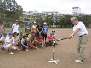 Medina resident and long-time baseball coach Phil Rognier demonstrates hitting a ball off the tee during his 16-day trip to Vietnam.