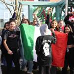 Allison DeAngelis/staff photo                                Students Maria Flores, Malammah Rubalcaba and their friends held a Mexican flag as they marched on Nov. 14.