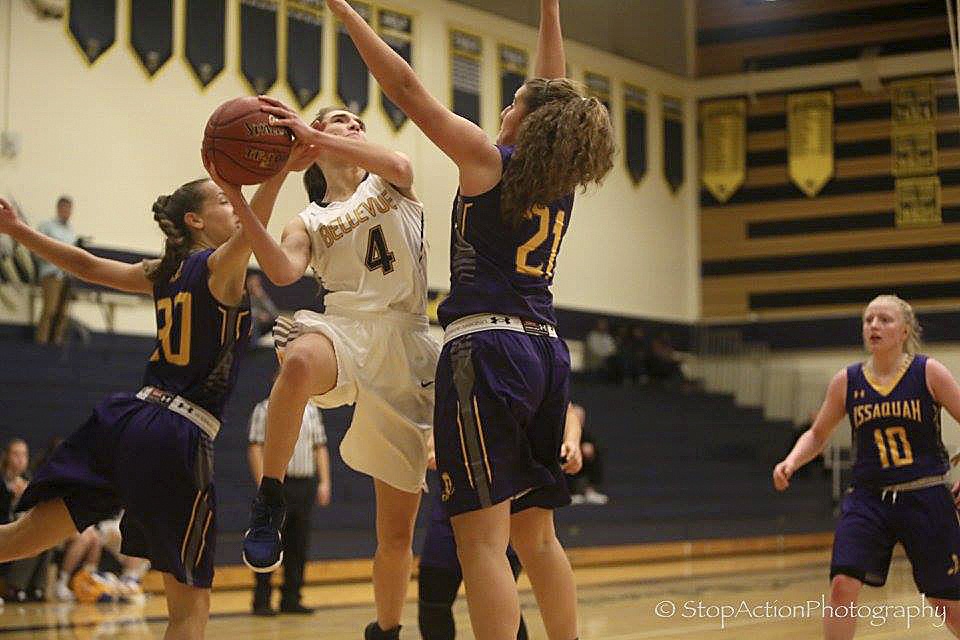 Bellevue Wolverines junior Annika Prins, left, attacks the basket while being defended by Issaquah Eagles player Mariah Van Halm, right, in a non-league matchup on Nov. 30 at Bellevue High School. The Wolverines defeated the Eagles 79-59.                                Photo courtesy of Don Borin/Stop Action Photography