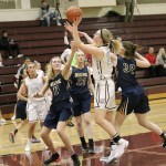 Photo courtesy of Willy Paine                                Mercer Island&rsquo;s Anna Luce, center, unleashes a perimeter shot while Bellevue&rsquo;s Kathryn Roberts, left, plays formidable defense on Dec. 12 at Mercer Island High School. The Islanders defeated the Wolverines 67-44.