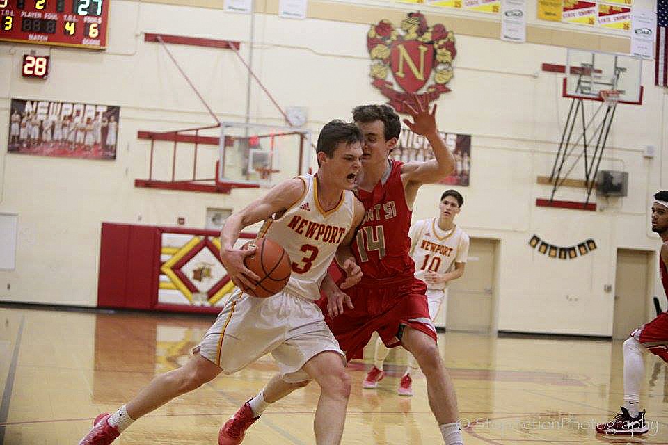 Photo courtesy of Don Borin/Stop Action Photography                                Newport Knights junior guard Elliot Thompson, left, drives to the basket while being covered by Mount Si guard Brett Williams. Mount Si picked up its first win of the season with a 71-37 victory on Dec. 19 in Factoria.