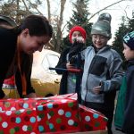 A volunteer helps pack presents into a family&rsquo;s vehicle during Bellevue LifeSpring&rsquo;s Holiday Adopt-A-Family event on Tuesday at First United Methodist Church of Bellevue. Allison DeAngelis/staff photos